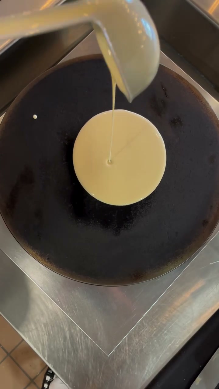 Creative Crepes secret batter being poured onto a hot griddle